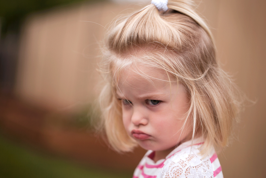 young girl with upset, pouting face